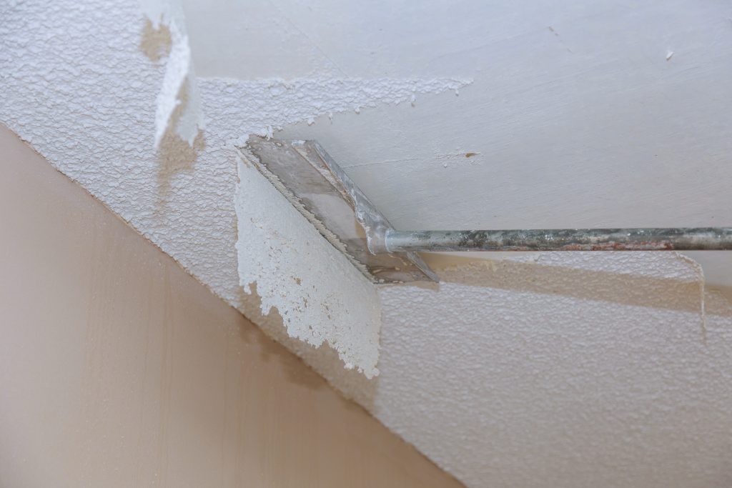 Scrapping a popcorn ceiling.
